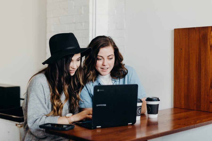 Two young women looking at a laptop